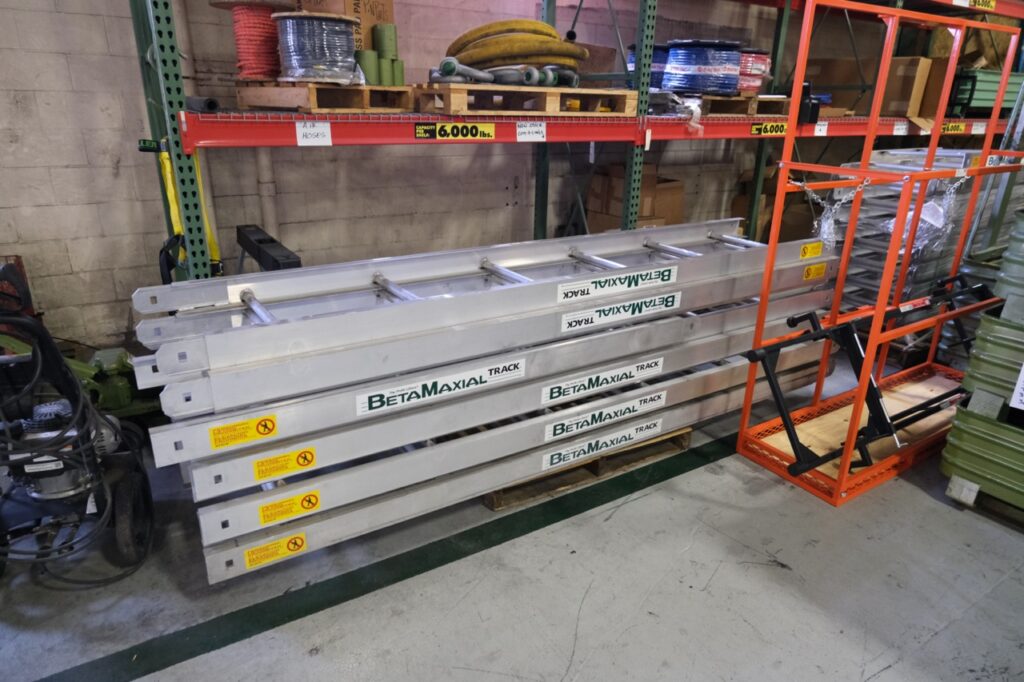 A disassembled Beta Max Maxial Track Hoist system inside of the LGH Rental Center.