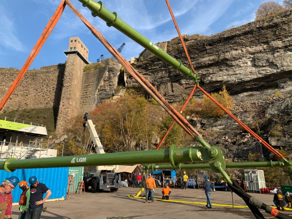 An industrial jobsite lift, featuring polyester round slings and modular spreader beam rentals from LGH.