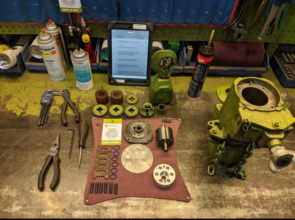 Photo of a disassembled air chain hoist rental from LGH on a work table.