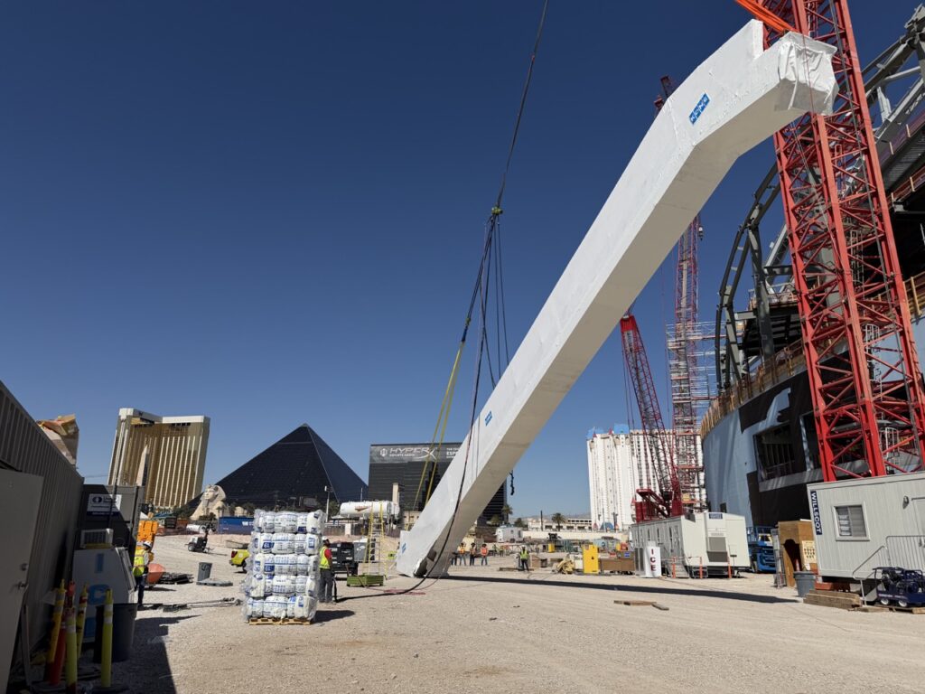 A jobsite photo of an LGH air chain hoist helping to lift an escalator at a stadium jobsite in Las Vegas.