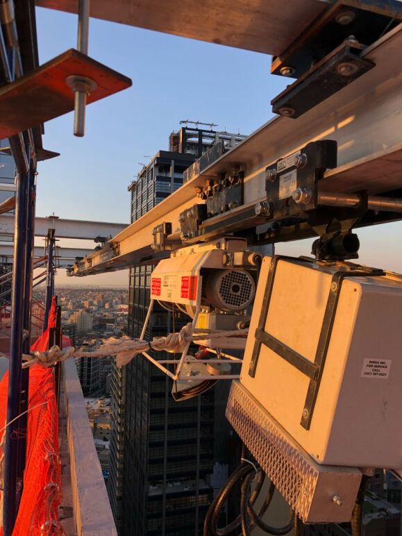 Example of a BETA MAX electric cable hoist rental from LGH on top of a tall building.