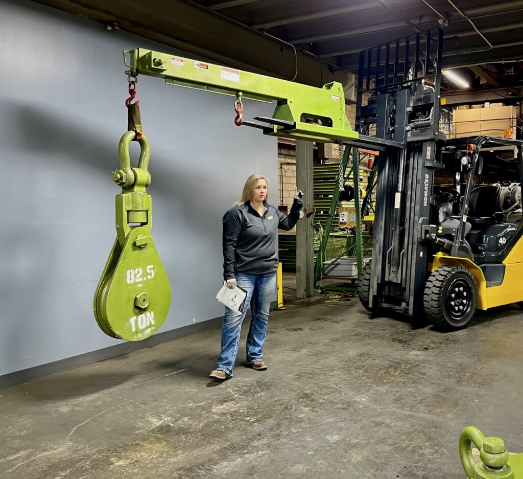 An 82.5 ton heavy duty snatch block, held up by a forklift boom in the LGH warehouse.