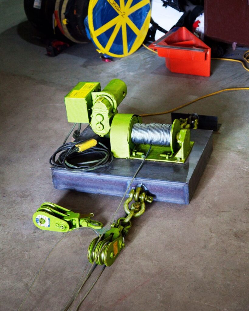 Snatch blocks from LGH with a winch and wire rope on the floor of an industrial jobsite.