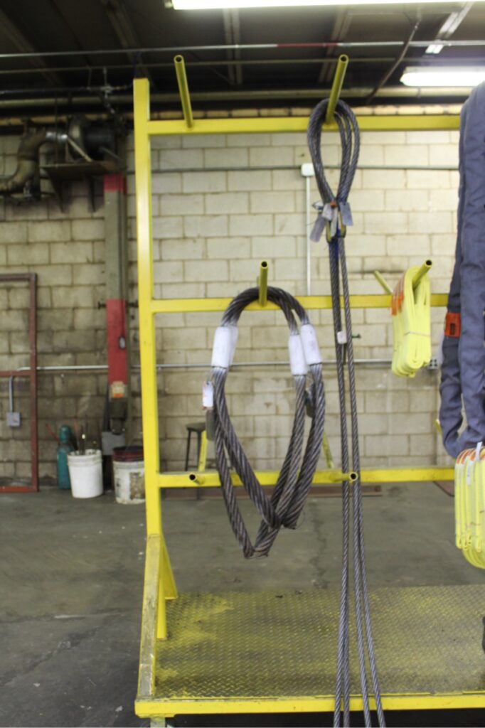 Wire rope slings properly stored on a rack in LGH Rental Center.