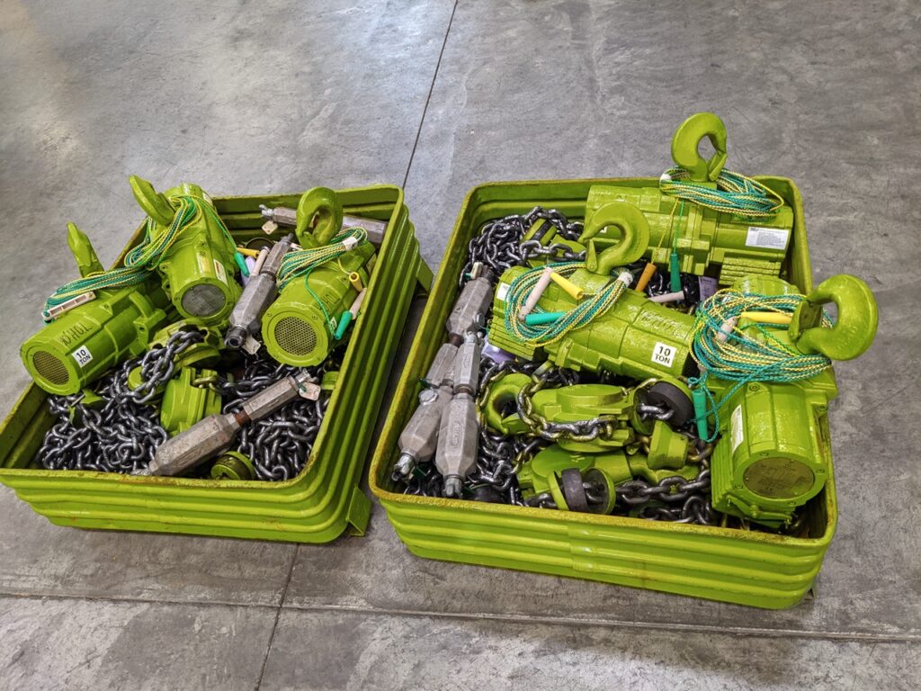 A photo of LGH air chain hoist rentals with oilers, dirt stoppers, and chain, inside a shipping container.