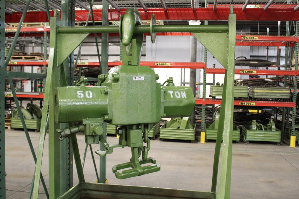 a heavy-duty 50-ton capacity air chain hoist rental from LGH, photographed inside a LGH Rental Center warehouse.