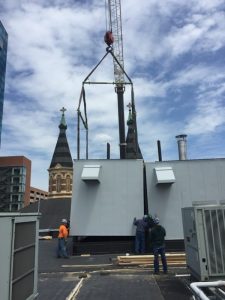 A steam boiler being lifted successfully onto a casino in Detroit, using lifting and rigging equipment from LGH.