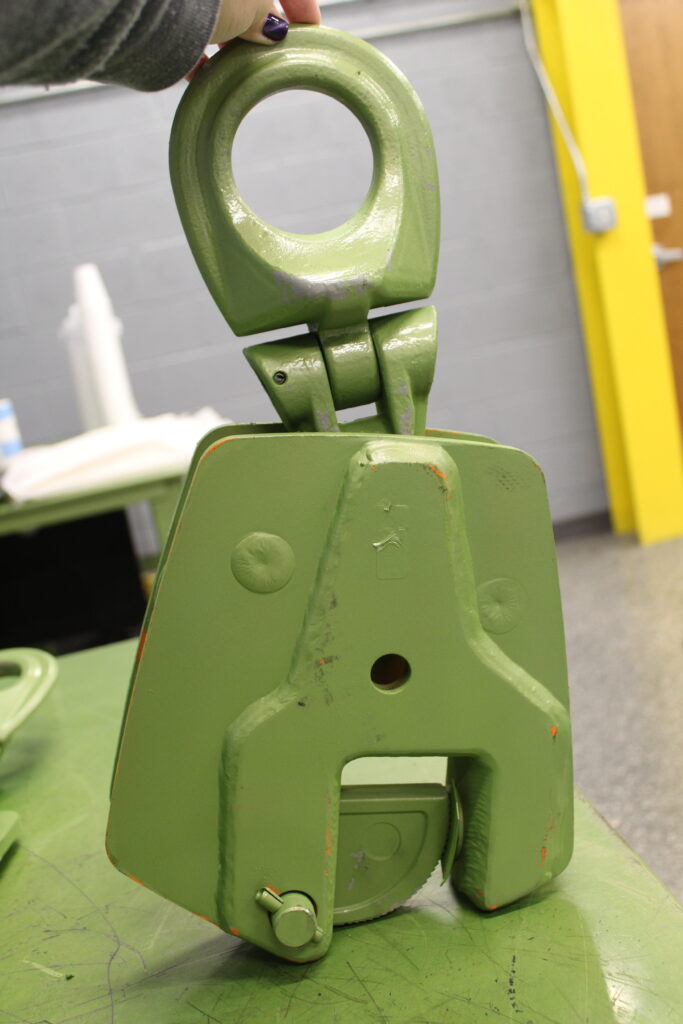 Photo of a green vertical clamp, from the LGH rental center training room.