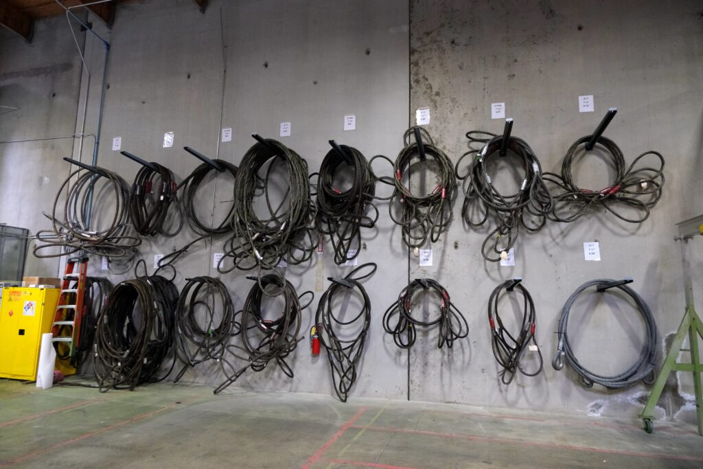 Photo of a wall of various wire rope slings from the LGH rental center warehouse.