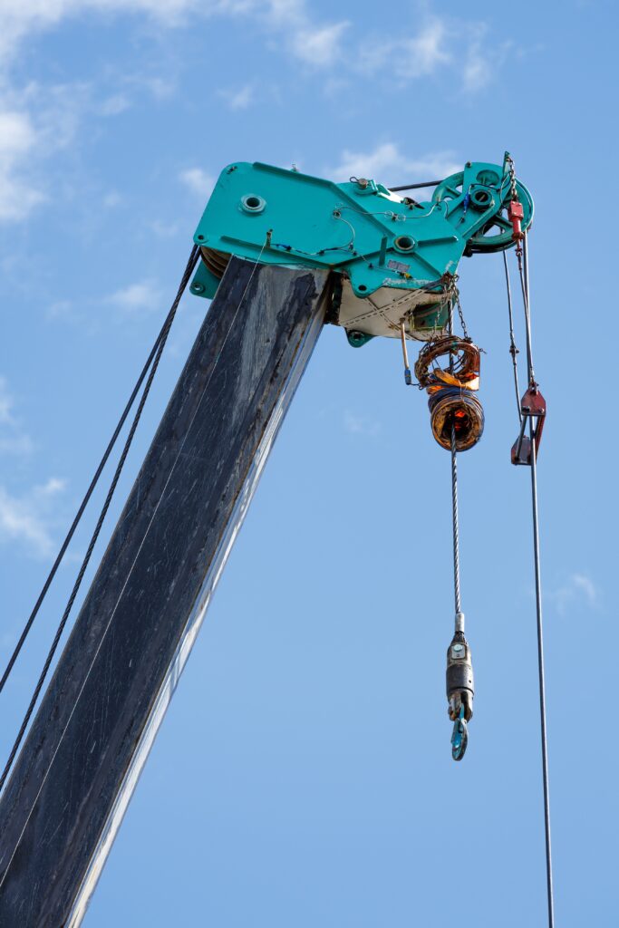 Stock photo of a crane with a line and swivel hook on the end.