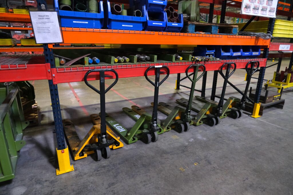 A photo of multiple manual pallet trucks inside an LGH rental center.