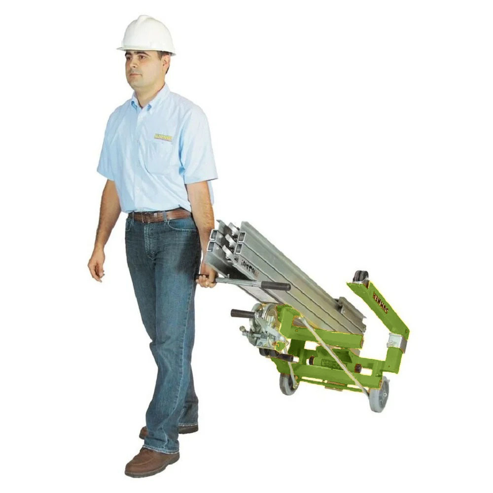 Photo of a man pulling a Sumner portable material lift rental from LGH.
