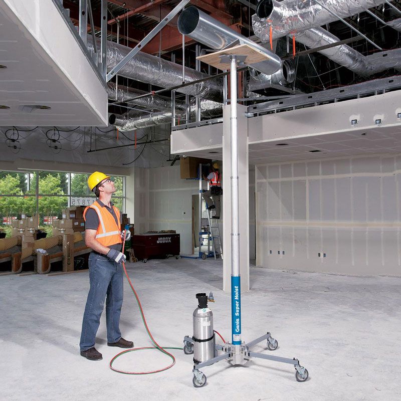 A jobsite photo demonstrating the Genie Super Hoist GH 3.8 lifting up some duct work