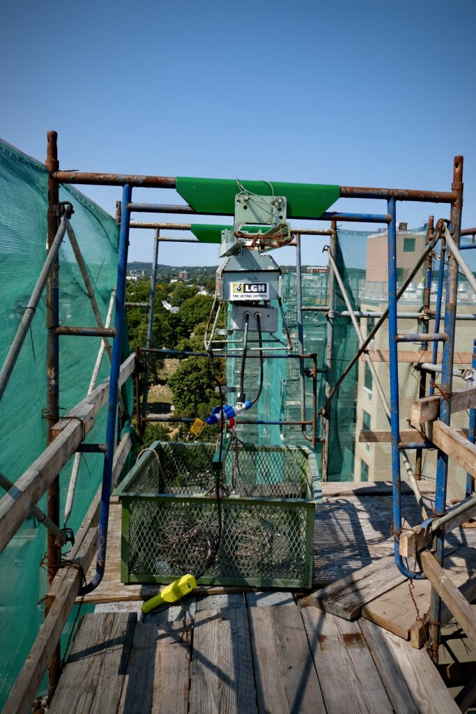 A Beta Max hoist on a jobsite, with an attached hoist basket rental from LGH.