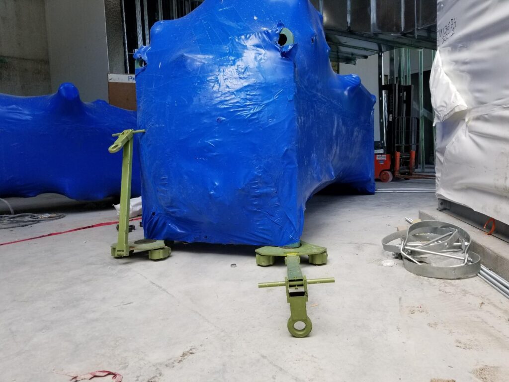 Rotating machine moving skates on a jobsite in Chicago, moving a heavy duty load.