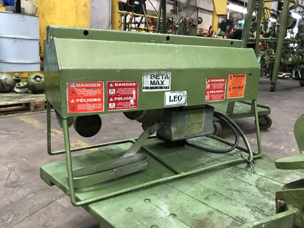 A photo of a Beta Max Leo Hoist painted in green inside the LGH Rental Center warehouse.