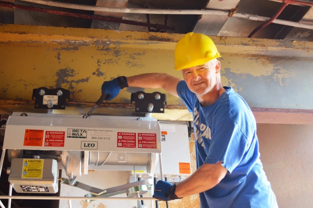 A construction worker, working on a Beta Max Leo Hoist from LGH.