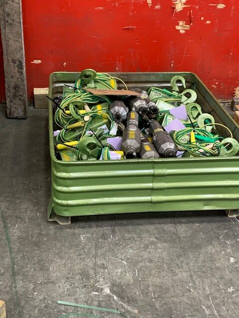 Jobsite photo of a shipping crate full of hoists, pneumatic oilers, and dirt stoppers from LGH.