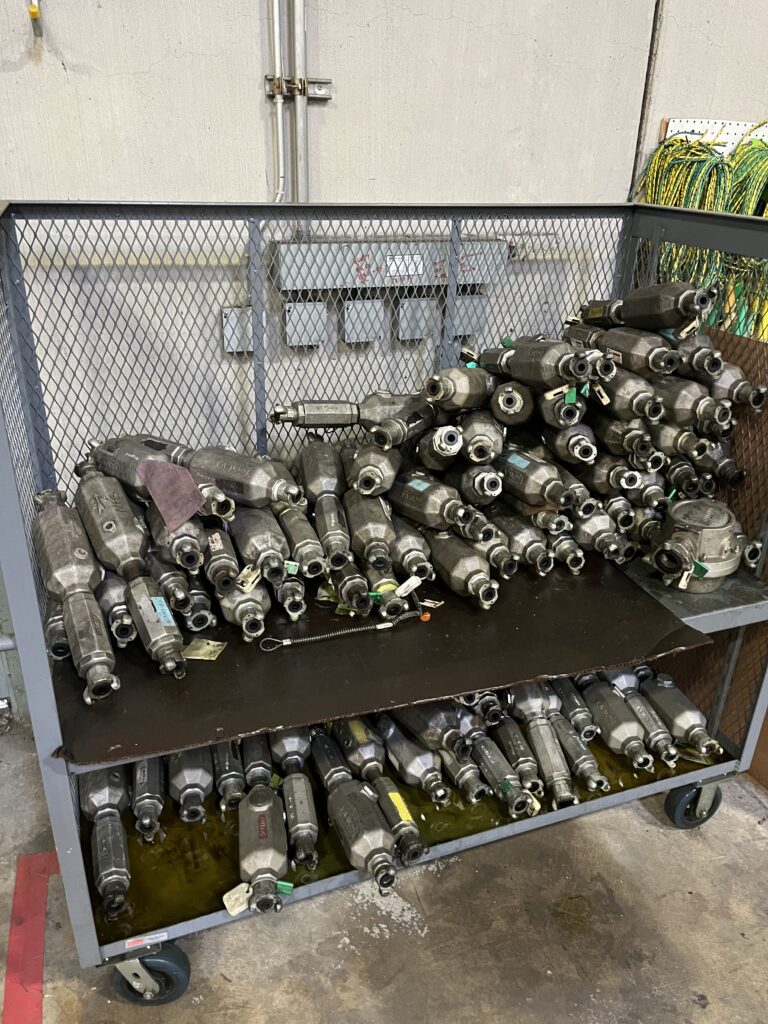 A photo of a rack of pneumatic oilers and dirt stoppers inside the LGH warehouse.