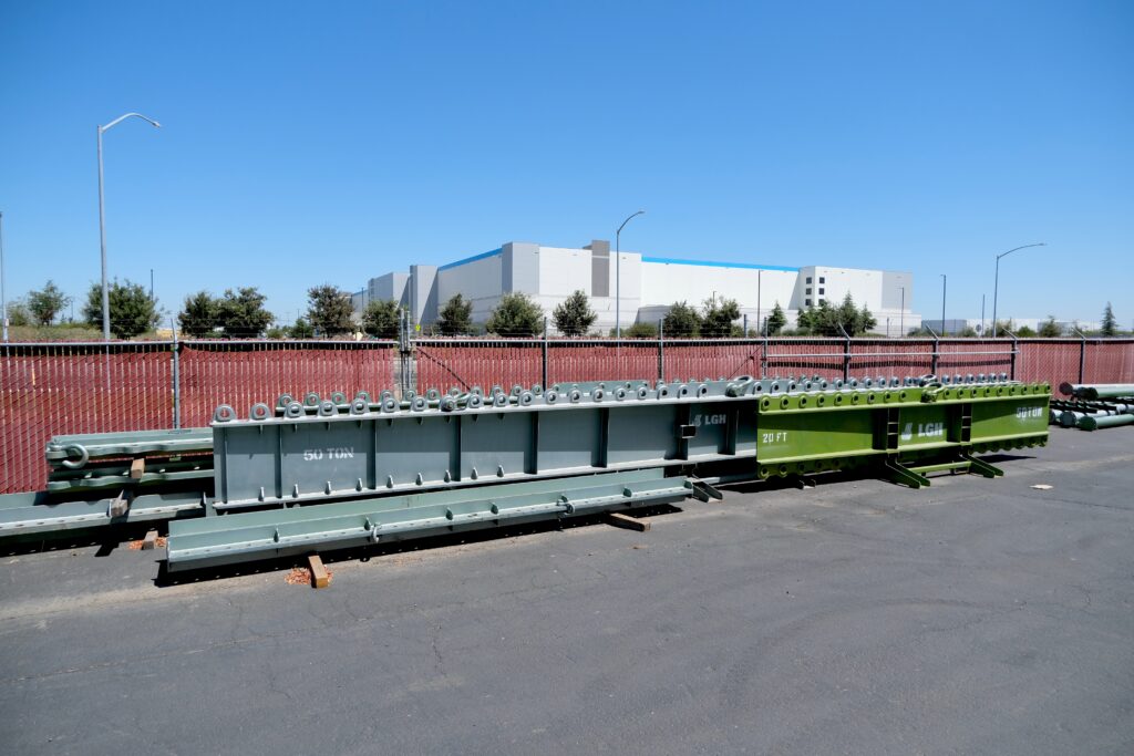A photo of heavy-duty lifting beams from LGH, sitting in the rental center yard.