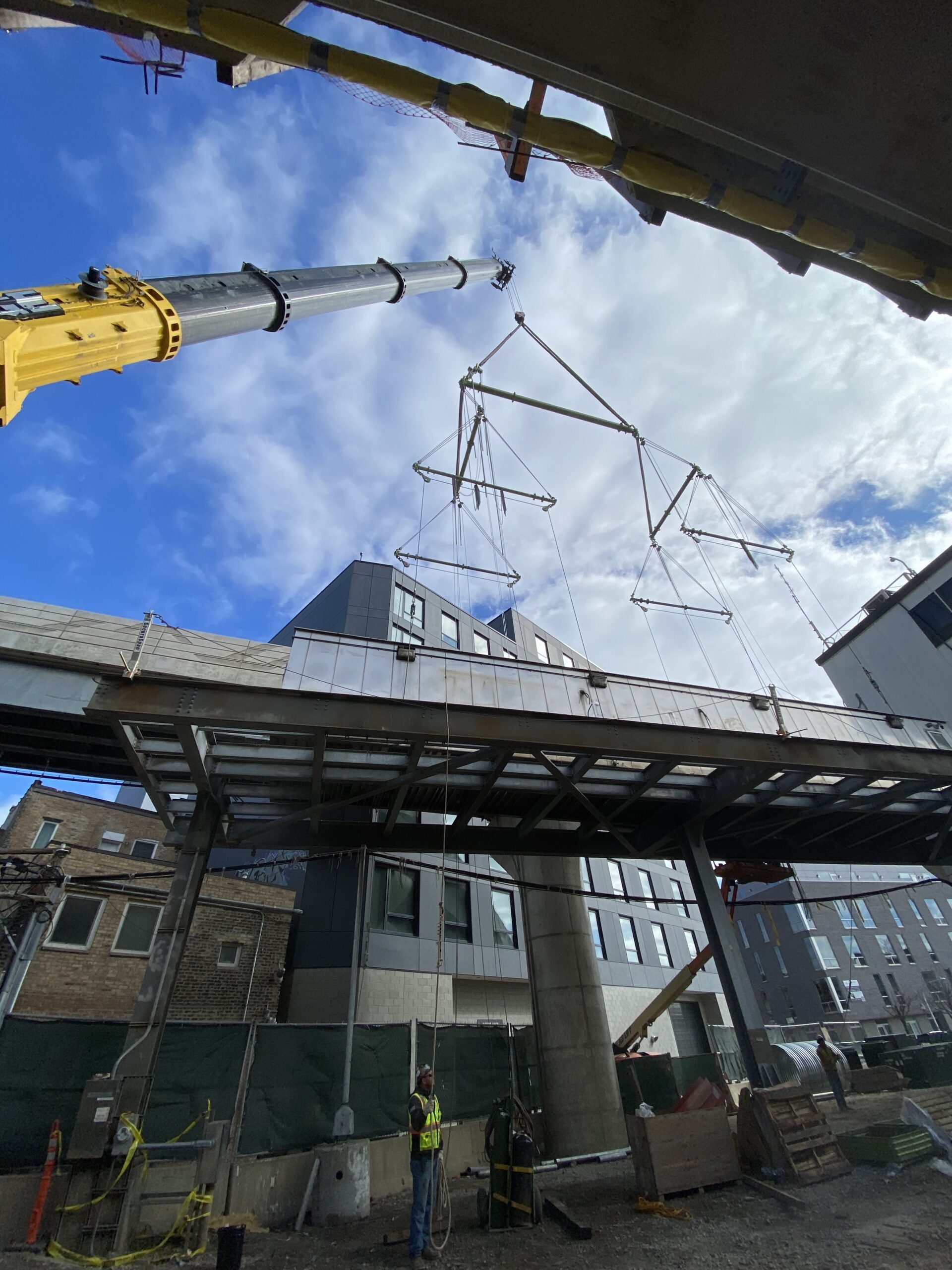 A crane lifting a section of the CTA train in Chicago, using rigging and lifting equipment from LGH.