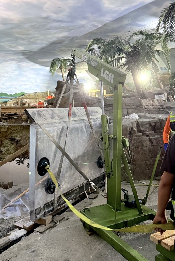 LGH floor crane lifting a glass panel for new shark exhibit at SeaWorld San Diego