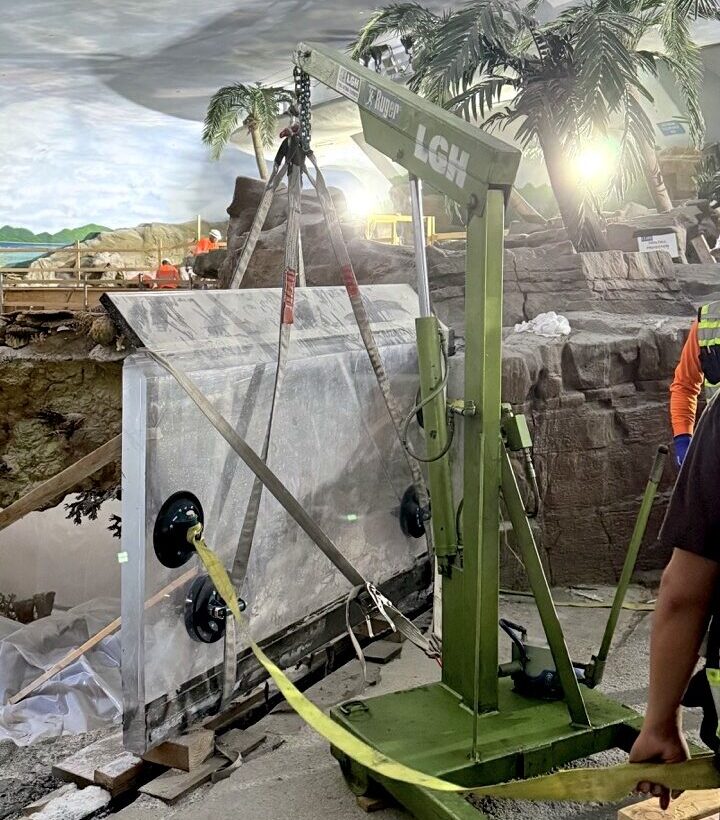 LGH floor crane lifting a glass panel for new shark exhibit at SeaWorld San Diego