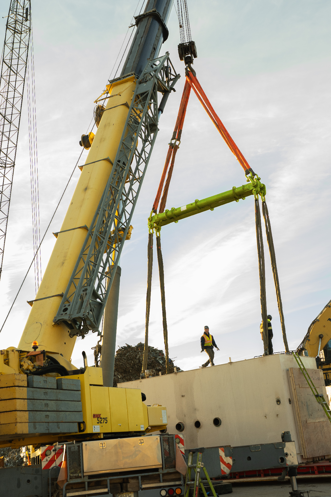 A modular lifting spreader beam from LGH, hanging under the hook of crane to lift a heavy load.