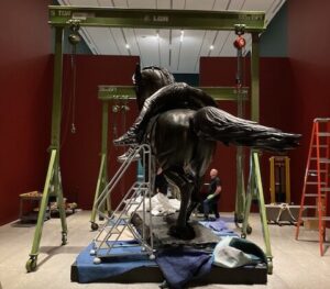 Gantry cranes used for statue installation at museum