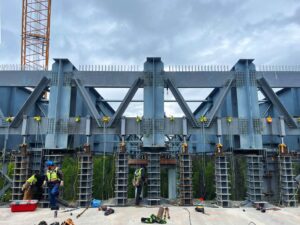 construction crew employs multiple hand chain hoists to assist with Alaska bridge installation