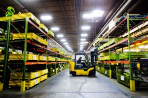 LGH rental center equipment on racks with forklift in use