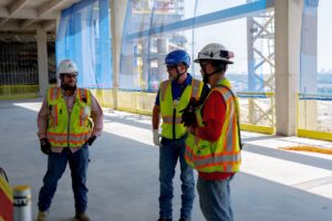 Foreman and project manager on construction jobsite discuss equipment rental options