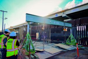 LGH Rental Reps in safety vest and hard hats discuss hydraulic gantry rental on jobsite